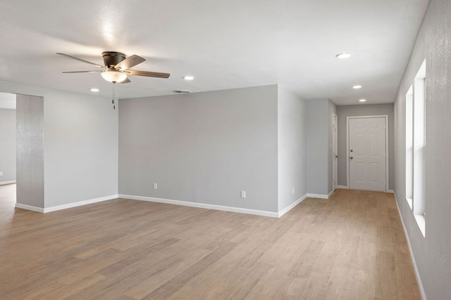 empty room featuring ceiling fan, recessed lighting, light wood-style flooring, and baseboards