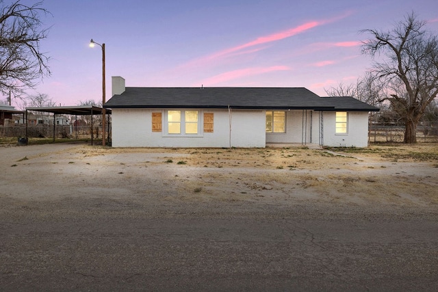 view of front of home featuring driveway, fence, and an attached carport