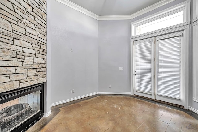 interior space featuring baseboards, ornamental molding, wood finished floors, and a stone fireplace