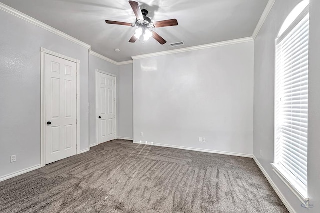 unfurnished bedroom featuring baseboards, carpet floors, and crown molding