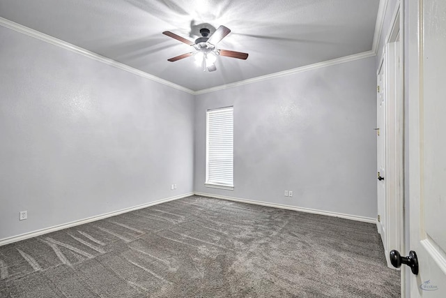 empty room with dark colored carpet, ornamental molding, a ceiling fan, and baseboards