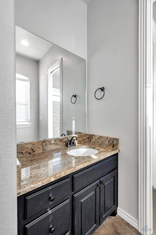 bathroom with vanity and baseboards