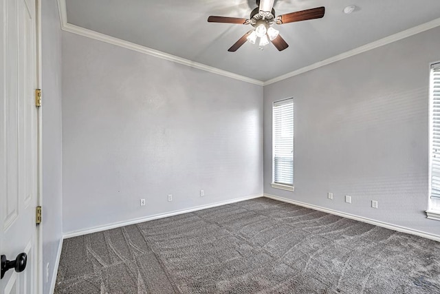 spare room featuring a ceiling fan, dark colored carpet, crown molding, and baseboards