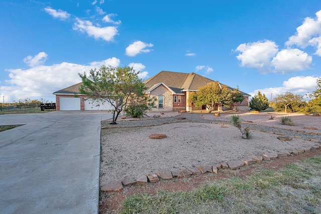 view of front of property featuring brick siding and driveway