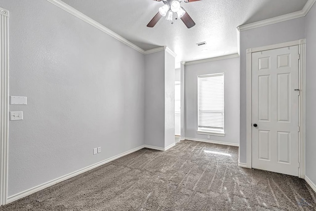 empty room featuring carpet, baseboards, ceiling fan, and crown molding