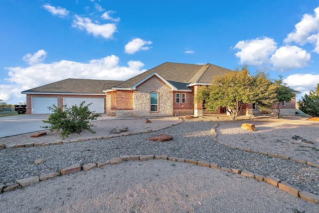 single story home featuring a garage, stone siding, roof with shingles, and driveway