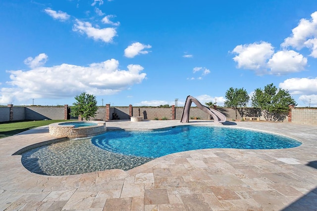 view of swimming pool with a patio, a water slide, a fenced backyard, and a pool with connected hot tub