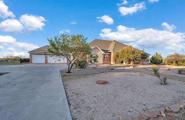 ranch-style house with a garage and concrete driveway