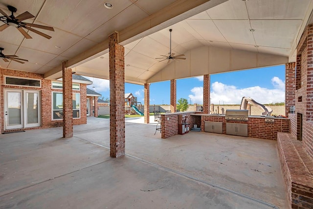 view of patio featuring a playground, grilling area, and exterior kitchen