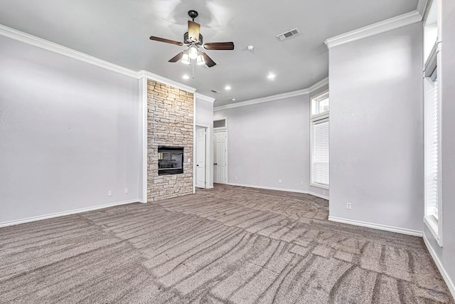 unfurnished living room featuring a stone fireplace, carpet flooring, visible vents, and crown molding