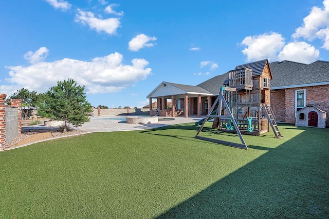 view of playground with a lawn and a patio