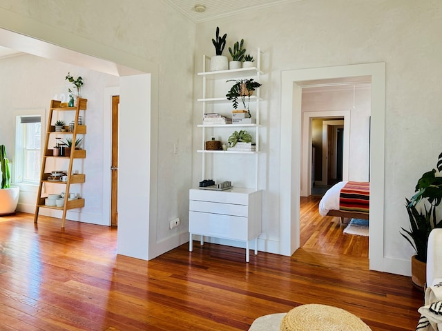 interior space featuring crown molding and hardwood / wood-style floors