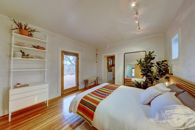 bedroom featuring light wood-type flooring and ornamental molding