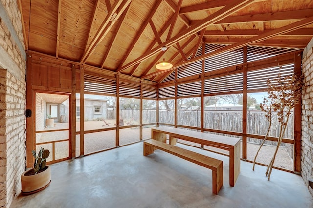 unfurnished sunroom featuring lofted ceiling