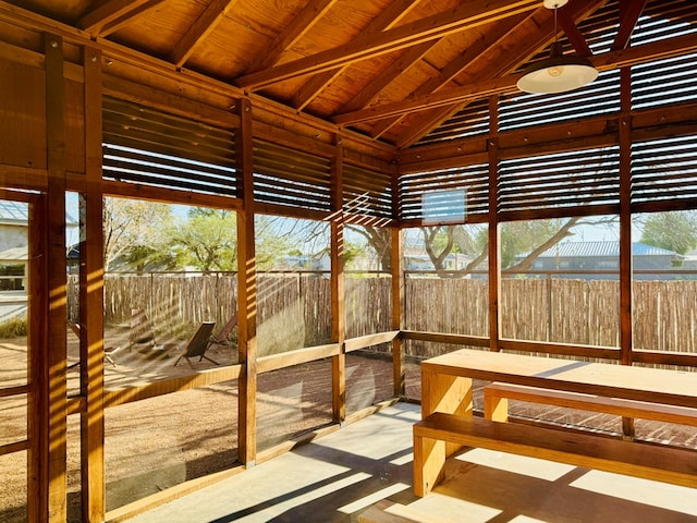 unfurnished sunroom with vaulted ceiling and wood ceiling