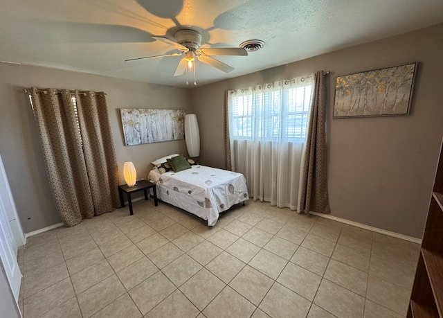 tiled bedroom with ceiling fan