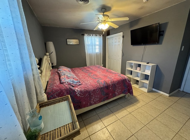 bedroom with ceiling fan and light tile patterned flooring