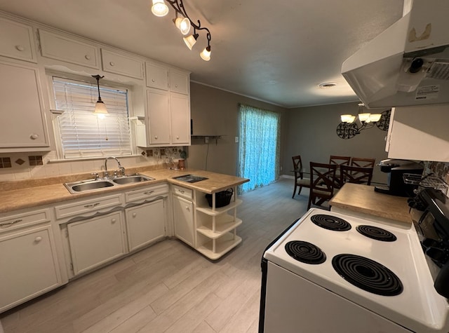 kitchen with white cabinets, decorative light fixtures, electric stove, and sink