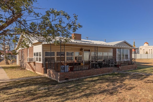 back of house featuring a yard