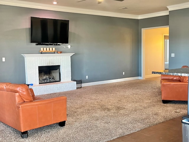 living room with carpet, ceiling fan, ornamental molding, and a brick fireplace