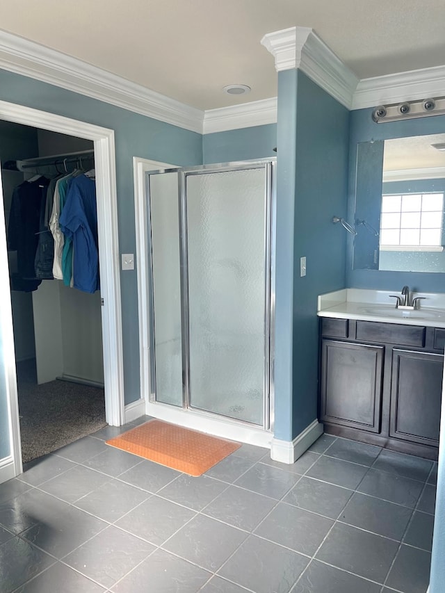 bathroom featuring tile patterned flooring, vanity, crown molding, and a shower with shower door