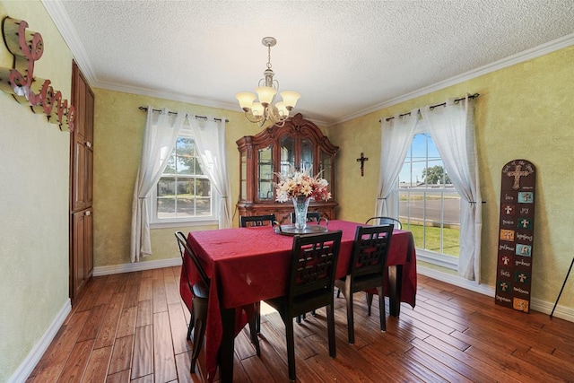 dining room featuring plenty of natural light, dark hardwood / wood-style flooring, and an inviting chandelier