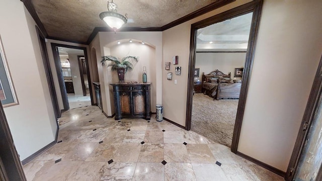 hallway with crown molding and light carpet