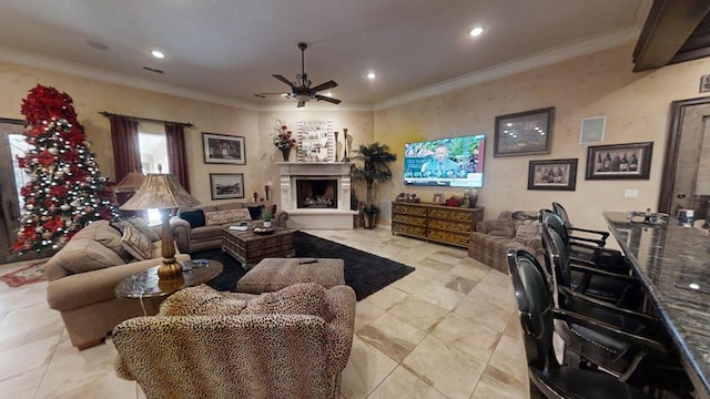 living room featuring ceiling fan and ornamental molding