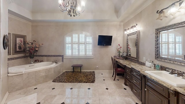 bathroom featuring ornamental molding, vanity, tiled bath, and a healthy amount of sunlight