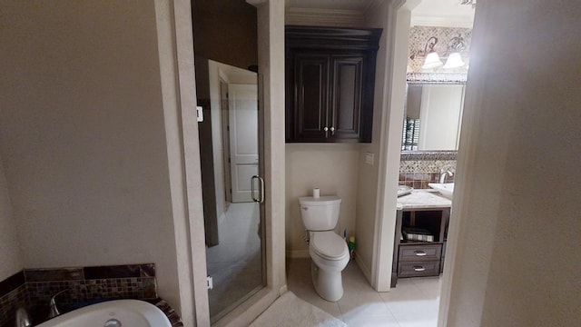 bathroom with tile patterned floors, toilet, ornamental molding, and independent shower and bath