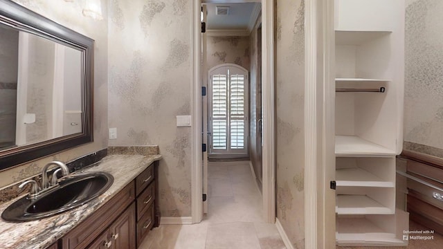 bathroom featuring tile patterned flooring and vanity