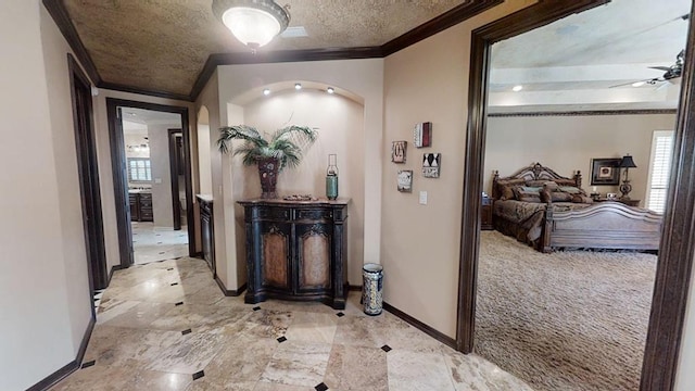 corridor featuring ornamental molding, light carpet, and a wealth of natural light