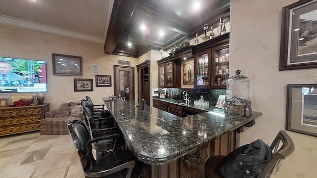 bar with dark brown cabinetry, beamed ceiling, dark stone countertops, crown molding, and light tile patterned floors