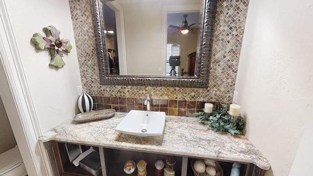 bathroom featuring vanity, tasteful backsplash, toilet, and ceiling fan