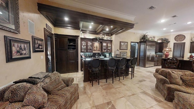 bar with dark brown cabinets, stainless steel fridge, and ornamental molding