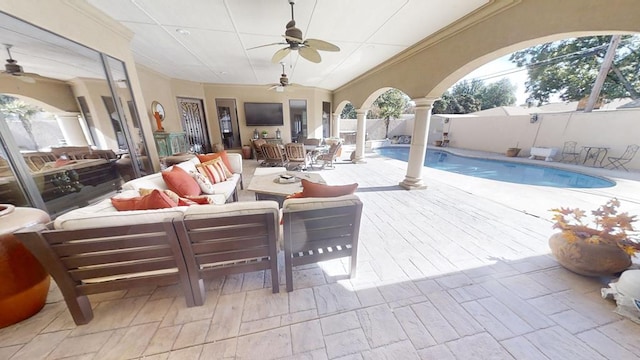 view of patio with outdoor lounge area, a fenced in pool, and ceiling fan