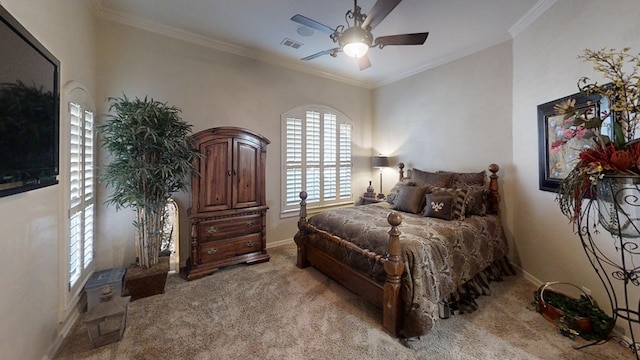 bedroom with ceiling fan, crown molding, and light carpet