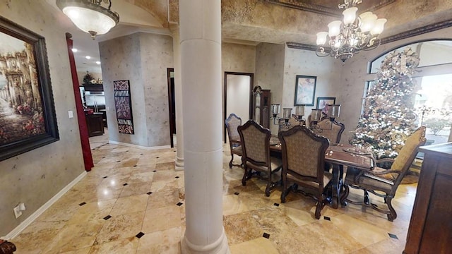 dining space with a chandelier and ornate columns