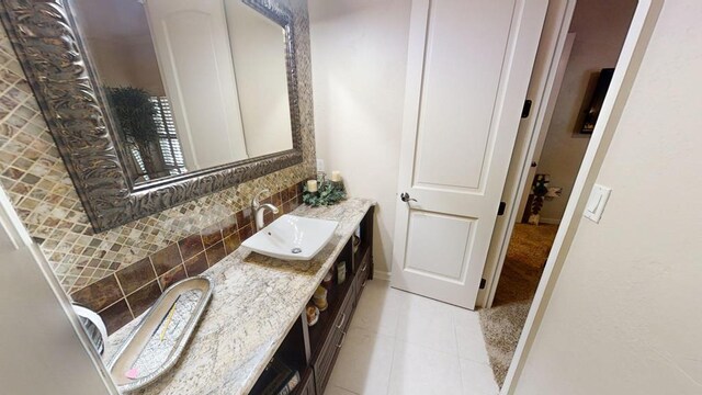 bathroom featuring decorative backsplash, vanity, and tile patterned flooring