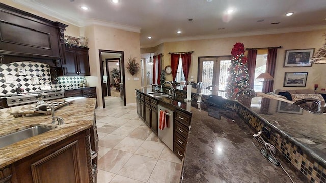 kitchen with tasteful backsplash, ornamental molding, stainless steel appliances, sink, and dark stone countertops