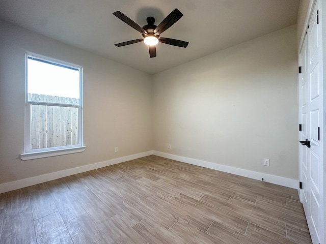 empty room with light hardwood / wood-style floors and ceiling fan