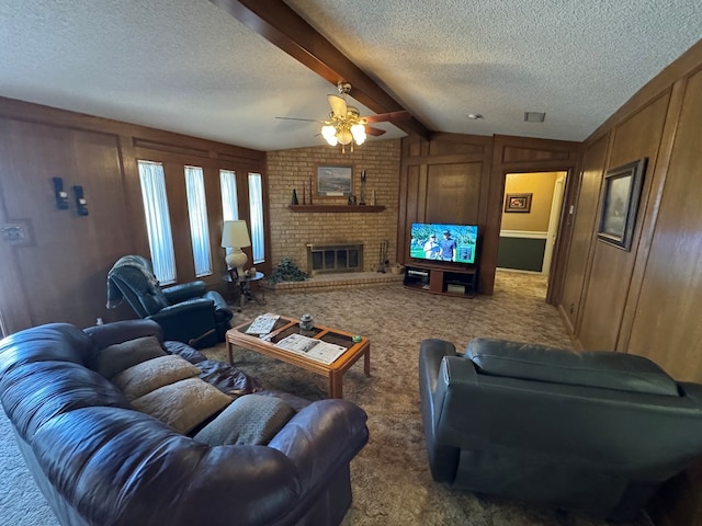 carpeted living area featuring wooden walls, a ceiling fan, vaulted ceiling with beams, a fireplace, and a textured ceiling