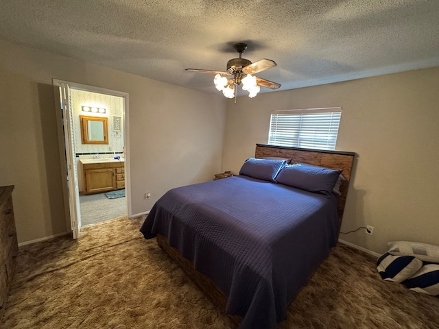 carpeted bedroom with a ceiling fan, baseboards, ensuite bathroom, and a textured ceiling