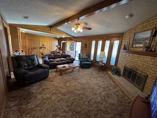 carpeted living room with vaulted ceiling with beams, a fireplace, visible vents, and wood walls