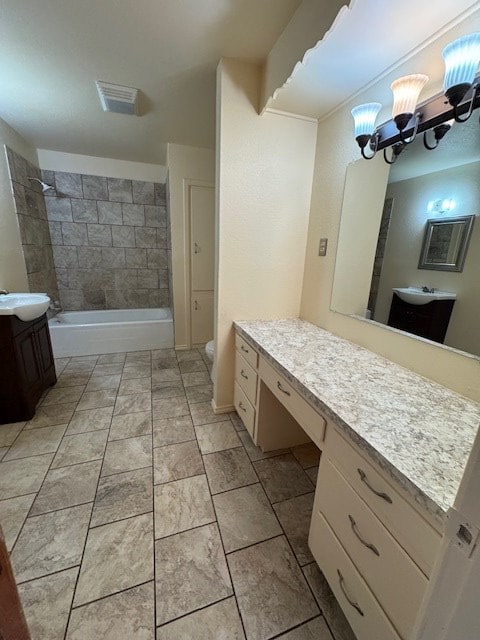 bathroom featuring visible vents, vanity, toilet, and an inviting chandelier