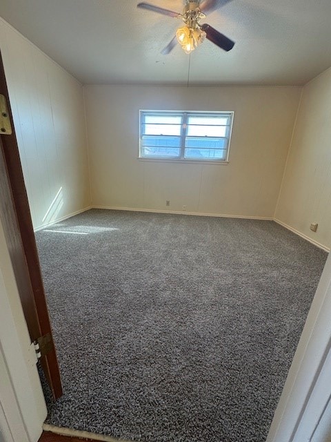 spare room with carpet and a ceiling fan