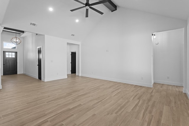 unfurnished living room featuring beam ceiling, light wood-type flooring, ceiling fan with notable chandelier, and high vaulted ceiling