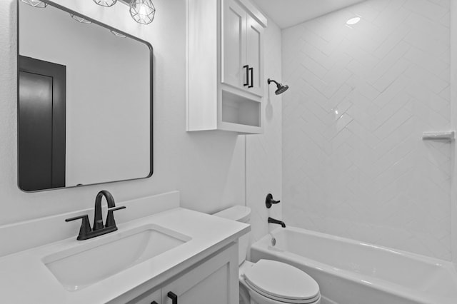 full bathroom with vanity, tiled shower / bath combo, and toilet