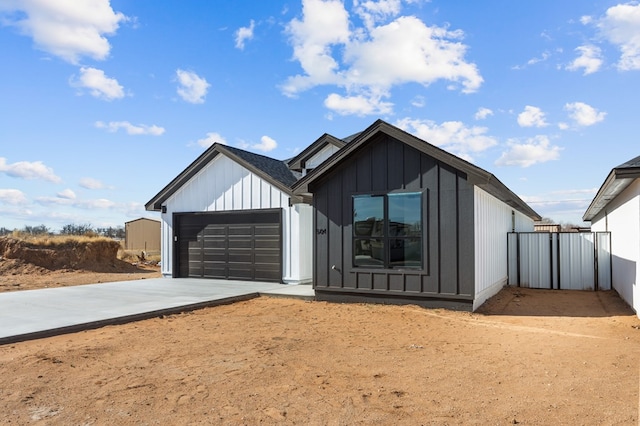 modern inspired farmhouse with a garage