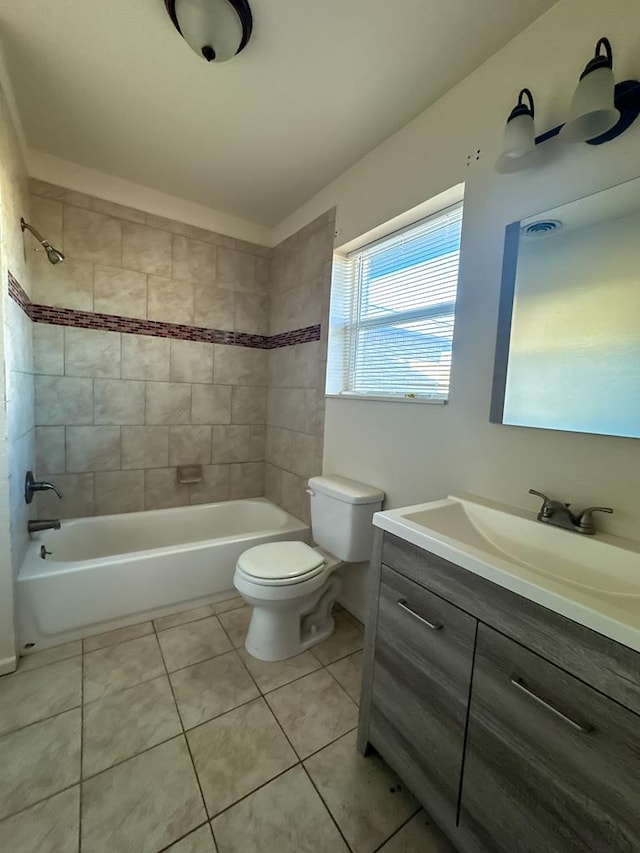 full bathroom with tile patterned floors, vanity, toilet, and tiled shower / bath combo